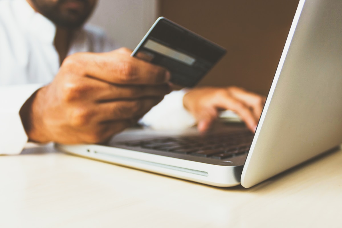 E-commerce operator reviewing orders and customer messages on laptop